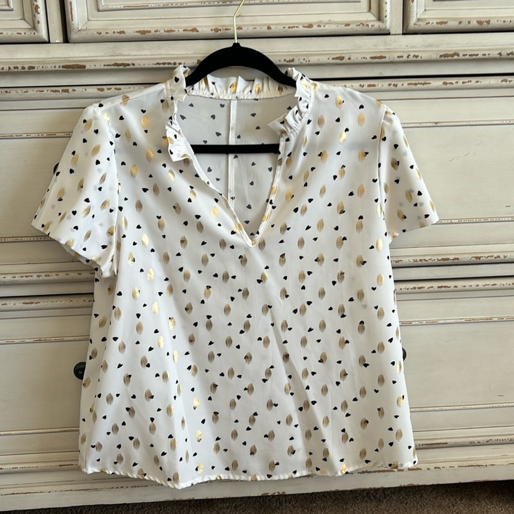 White blouse with black and gold details